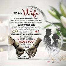 A heart-shaped acrylic keepsake plaque featuring text and a silhouette of two hands holding, with a dark background.