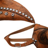 A close-up of a brown leather plague doctor bird mask with silver studs and a matching strap.