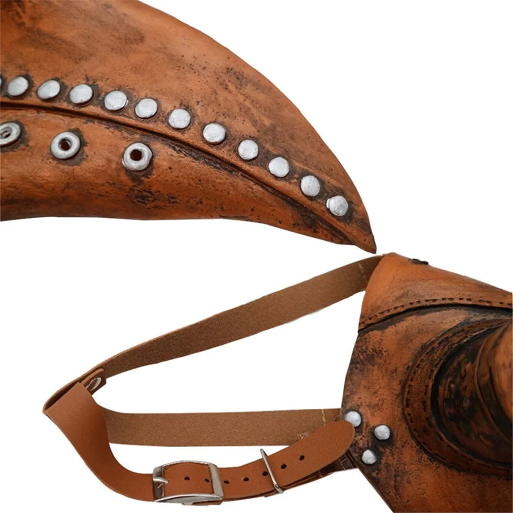 A close-up of a brown leather plague doctor bird mask with silver studs and a matching strap.