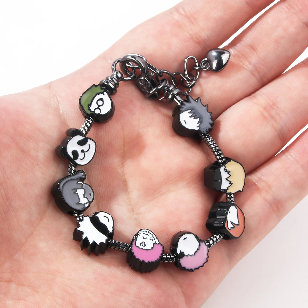 A silver charm bracelet featuring miniature figures of Itadori, Fushiguro, and Gojo from Jujutsu Kaisen.