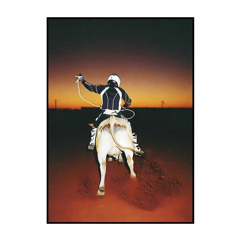 A silhouette of a rider on a horse against an orange sunset sky, rendered in canvas wall art.