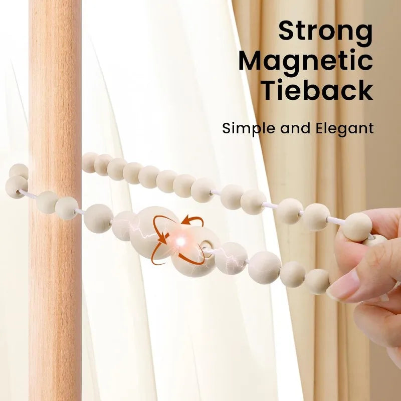 Two magnetic wooden bead curtain tiebacks with a decorative clasp are shown against a light-colored curtain.