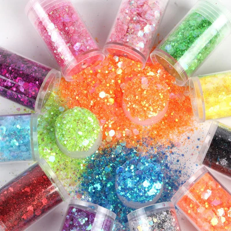 A collection of 32 colorful glitter mixes in small plastic containers, showcasing various shades for nail art and DIY crafts.