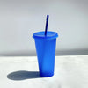 A bright blue glitter party cup with a straw is shown against a white background.