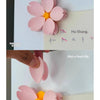 Pink magnetic cherry blossom sealing clips falling on blackberries.
