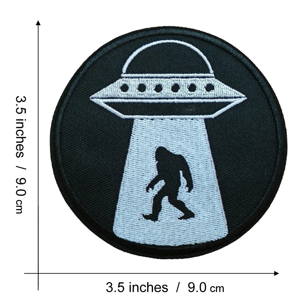 Black embroidered patch featuring a silhouette of Bigfoot standing inside a stylized helmet shape.