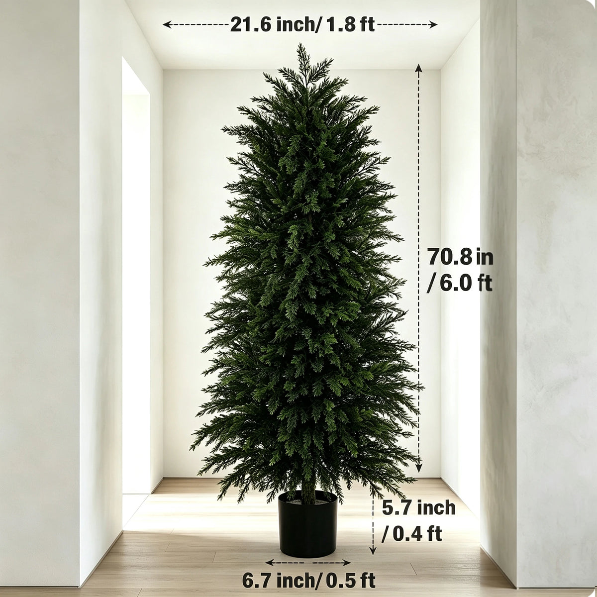 A tall artificial cedar topiary tree in a black pot displayed in a bright indoor setting.