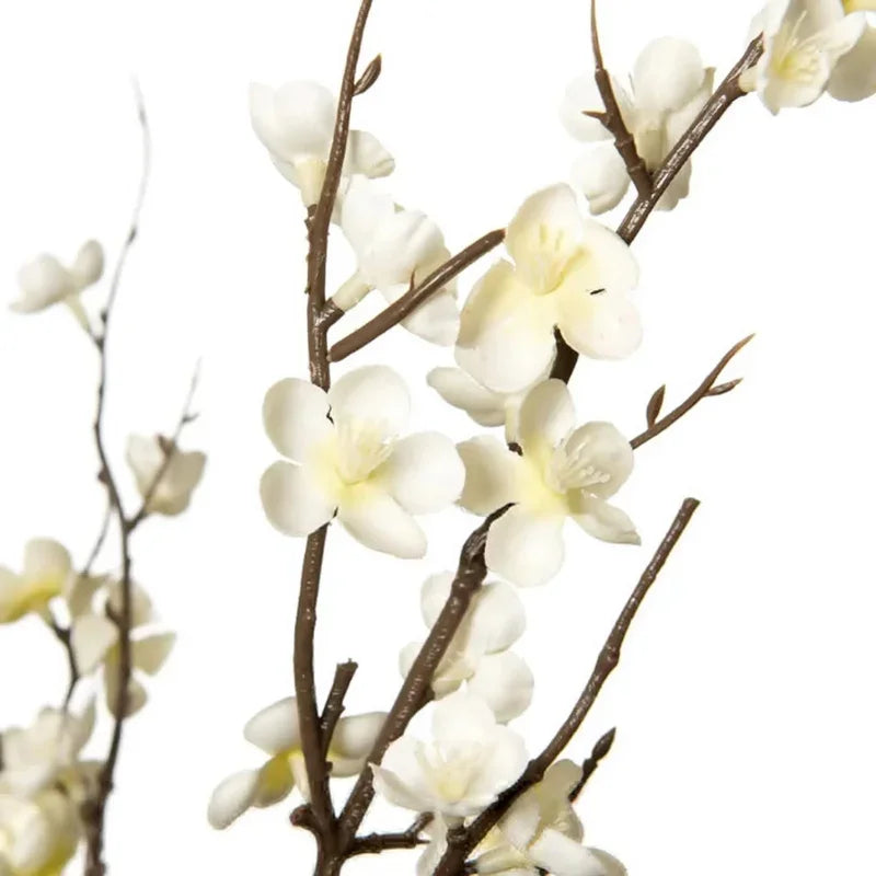 A branch of white faux plum blossoms with stems.
