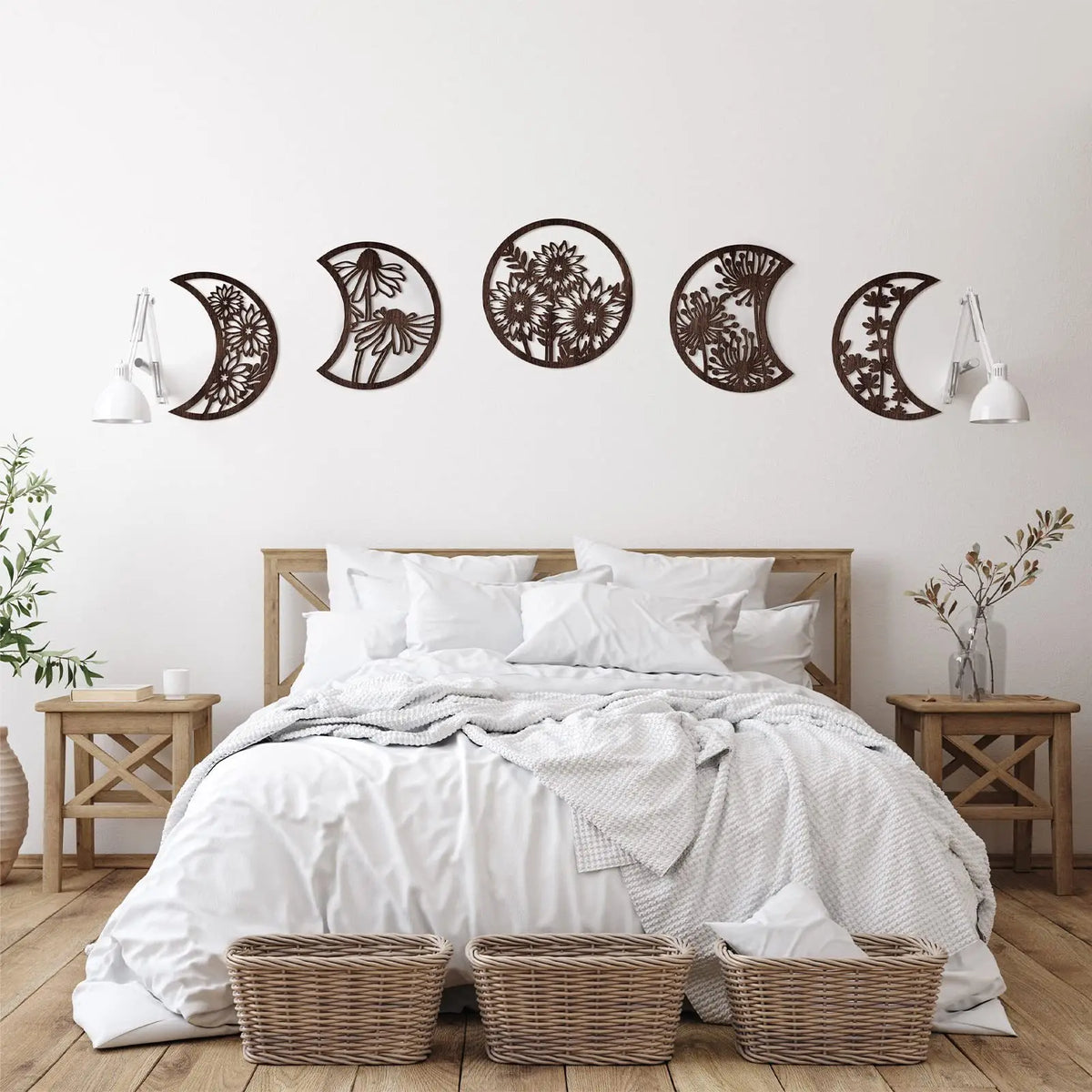 Nordic wooden moon phase wall art featuring various crescent and full moon shapes on a white wall above a bed.