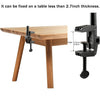 Black adjustable frame and clamp mechanism for fixing items on a table.