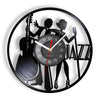 A wall clock face featuring silhouettes of musicians playing instruments like a saxophone and drum set.
