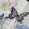 A collection of colorful butterfly stickers and embellishments on a page of a journal.
