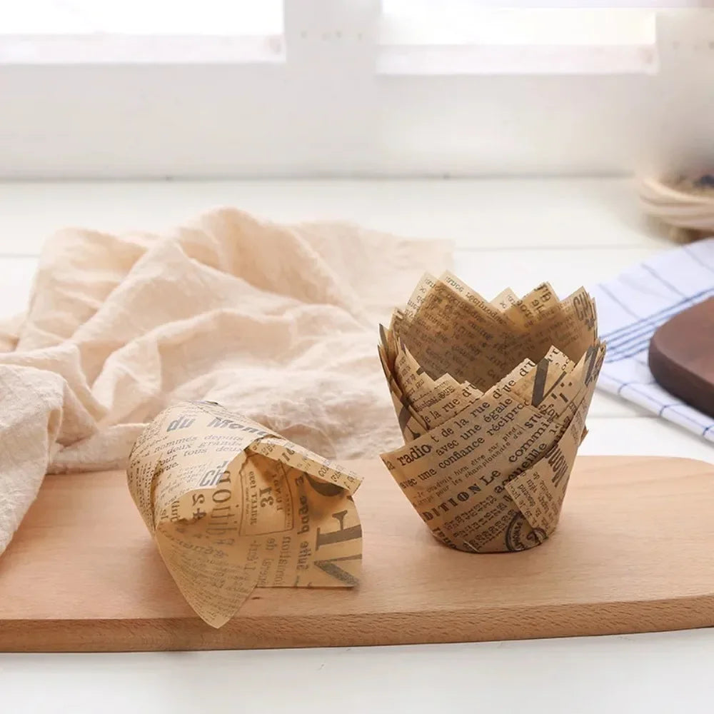 A small terracotta cup filled with crumpled newspaper style cupcake liners resting on a wooden board.