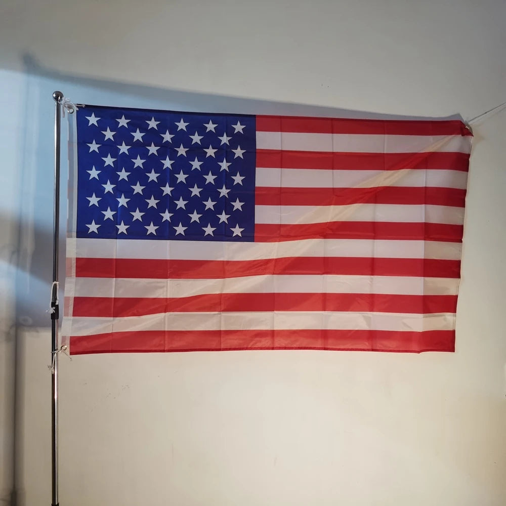 A decorative banner displaying the flag of the United States of America hanging on a wall.