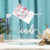 A clear acrylic box displays a stack of cards with pink and red floral accents on a white background.