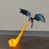 A black dragon silhouette with outstretched wings is shown emitting a bright orange flame effect.