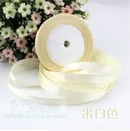 Roll of cream or ivory silk satin ribbon used for wrapping