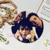 A set of collectible brooches featuring portraits of punk band members on album cover style pins.