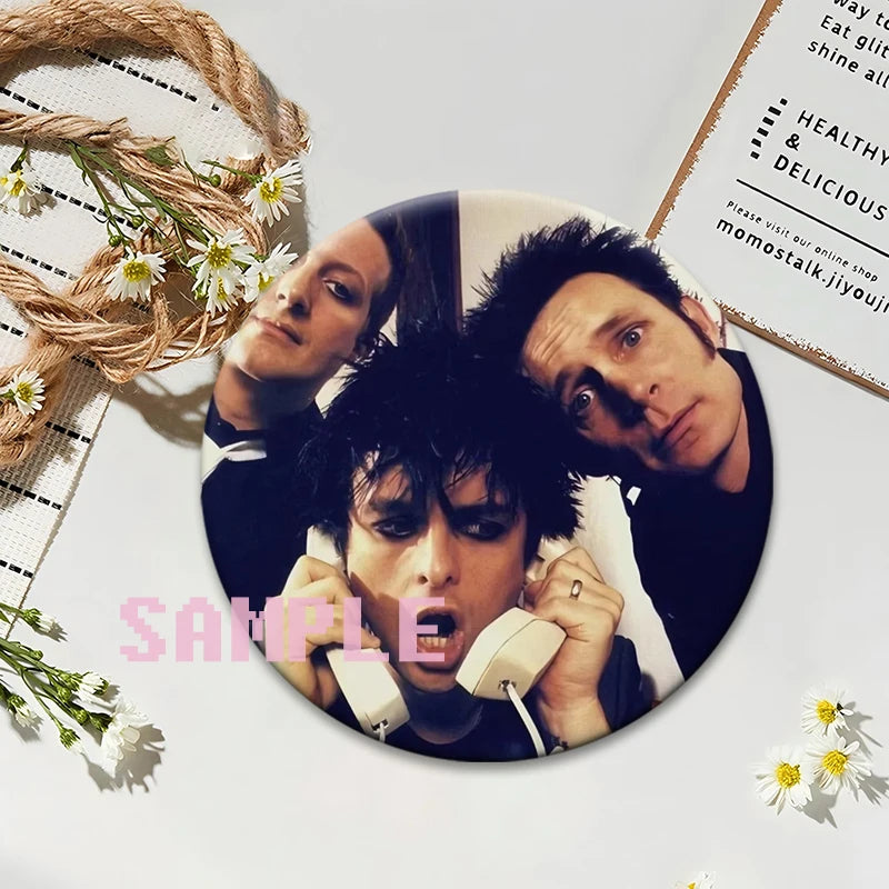 A set of collectible brooches featuring portraits of punk band members on album cover style pins.