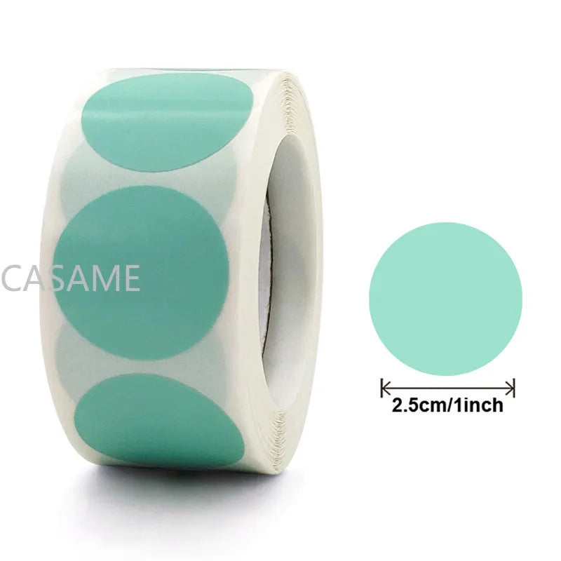 Roll of heart-shaped seal stickers in mint green and white on a white background