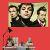 A decorative banner featuring three portraits of Green Day band members against a light green background.