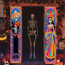 Two vertical banners featuring sugar skull designs and vibrant colors displayed on a dark door.