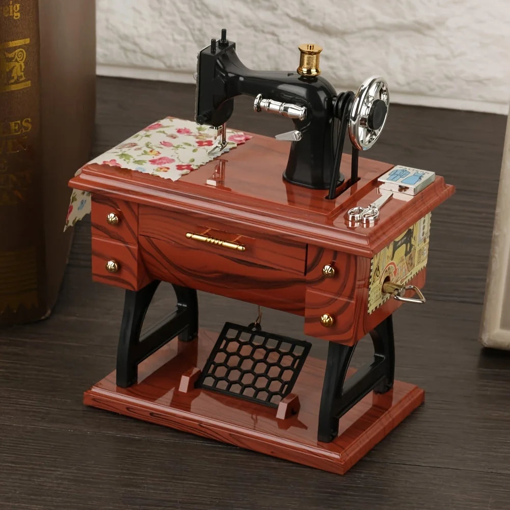 A vintage clockwork music box featuring a black iron and silver mechanism displayed on a wooden desk.