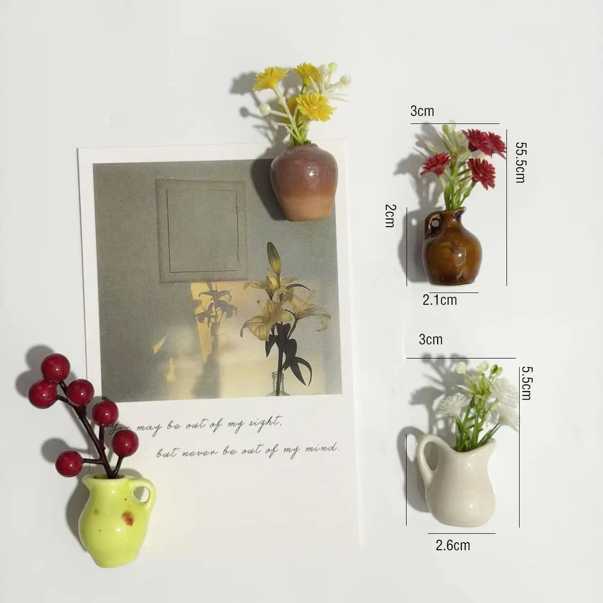 A collection of mini ceramic vases with artificial flowers shown next to a card displaying dimensions.