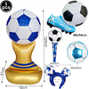 A set of inflatable soccer balls, a football-themed shoe, and a gold stand for party decoration.