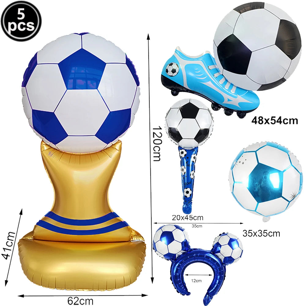 A set of inflatable soccer balls, a football-themed shoe, and a gold stand for party decoration.
