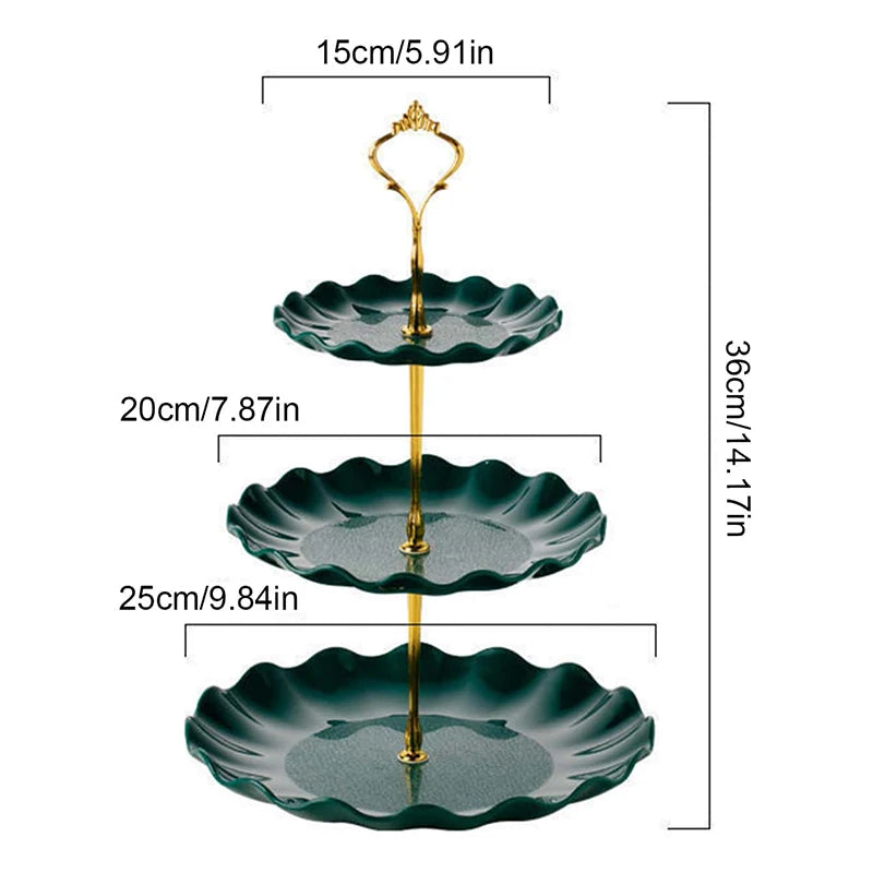 A two-tier serving stand with gold accents, featuring dark green, scalloped plates for desserts or fruit.