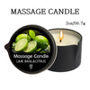 A black jar of massage candle with a lit wick and lime basil citrus ingredients visible.
