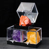 A clear acrylic display box holds a reddish-orange crystal rough stone specimen and a yellow crystal rough stone specimen.