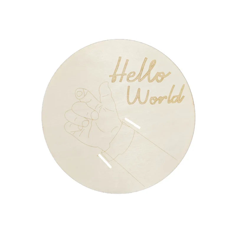 A round, translucent light sign with the text Hello World and a hand outline etched on it.