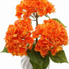 A cluster of bright orange artificial hydrangea flowers on green leaves.