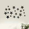 A set of black 3D acrylic star wall decor mounted on a light-colored wall.
