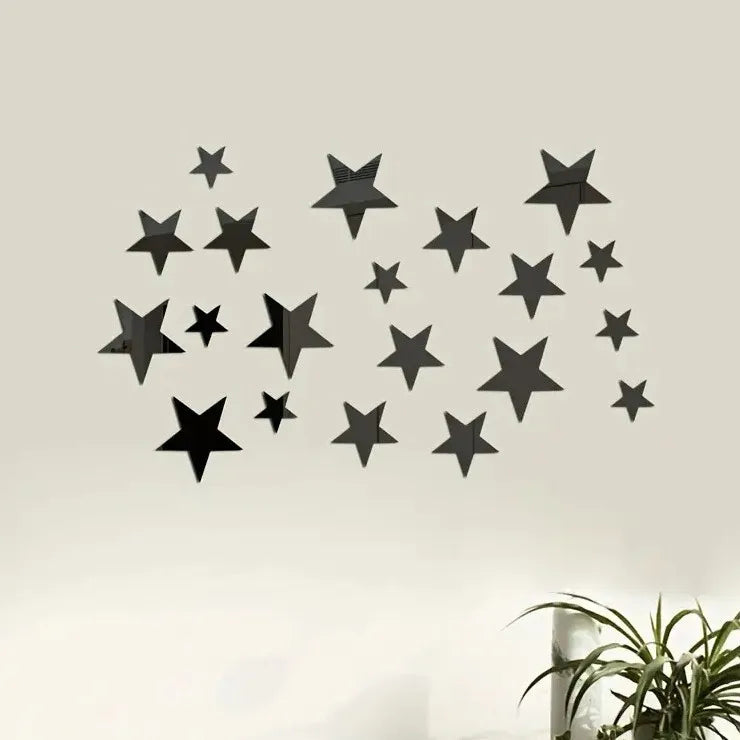 A set of black 3D acrylic star wall decor mounted on a light-colored wall.