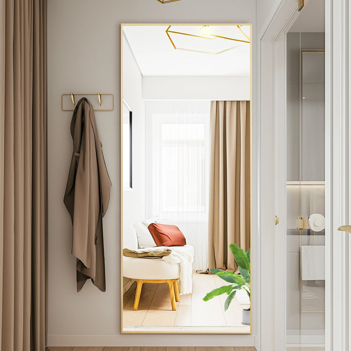 A modern arched full-length mirror with a gold frame is shown in a bright interior with neutral tones and sheer curtains.