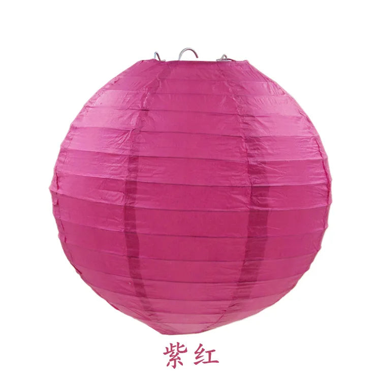 A large, round, pink paper lantern with a translucent texture.