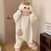 A white coral fleece hooded sleepsuit resembling a monster with pink accents.