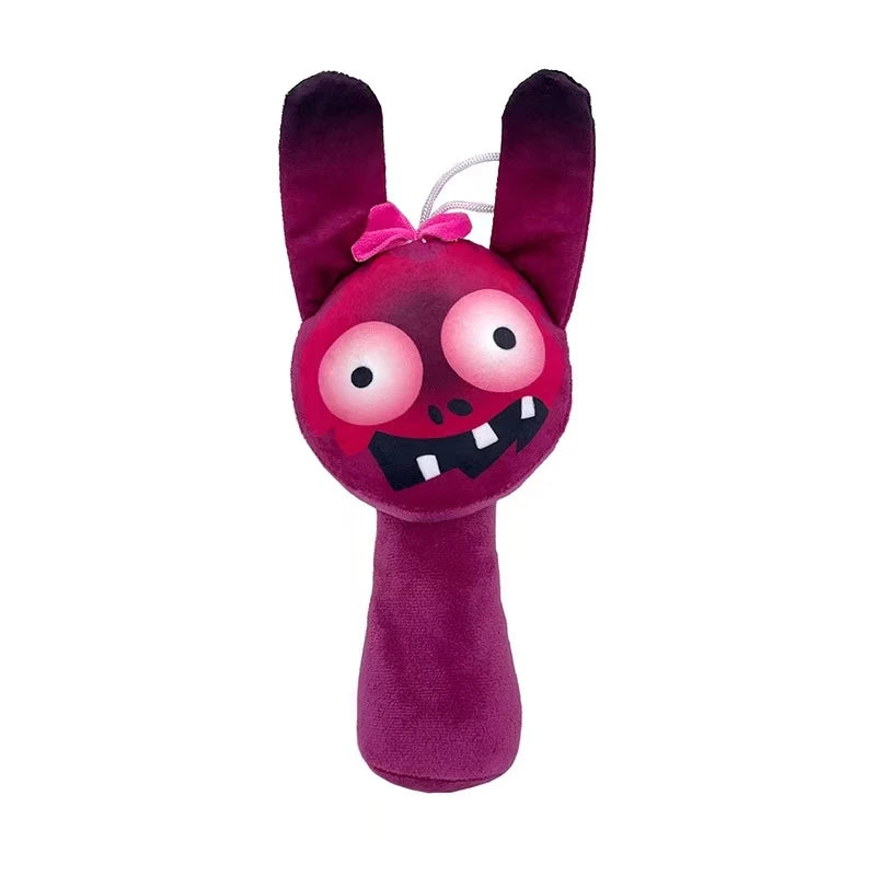 A plush toy of a purple monster with large eyes and sharp teeth, featuring pink accents.