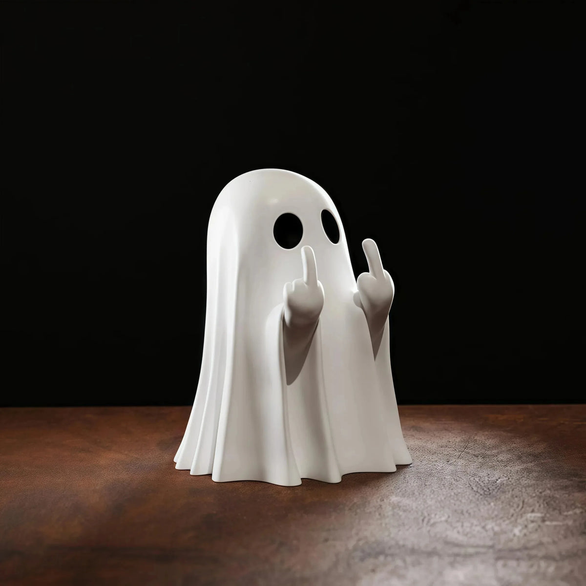 A white ghost figurine with a cheeky gesture is displayed on a dark wooden surface.