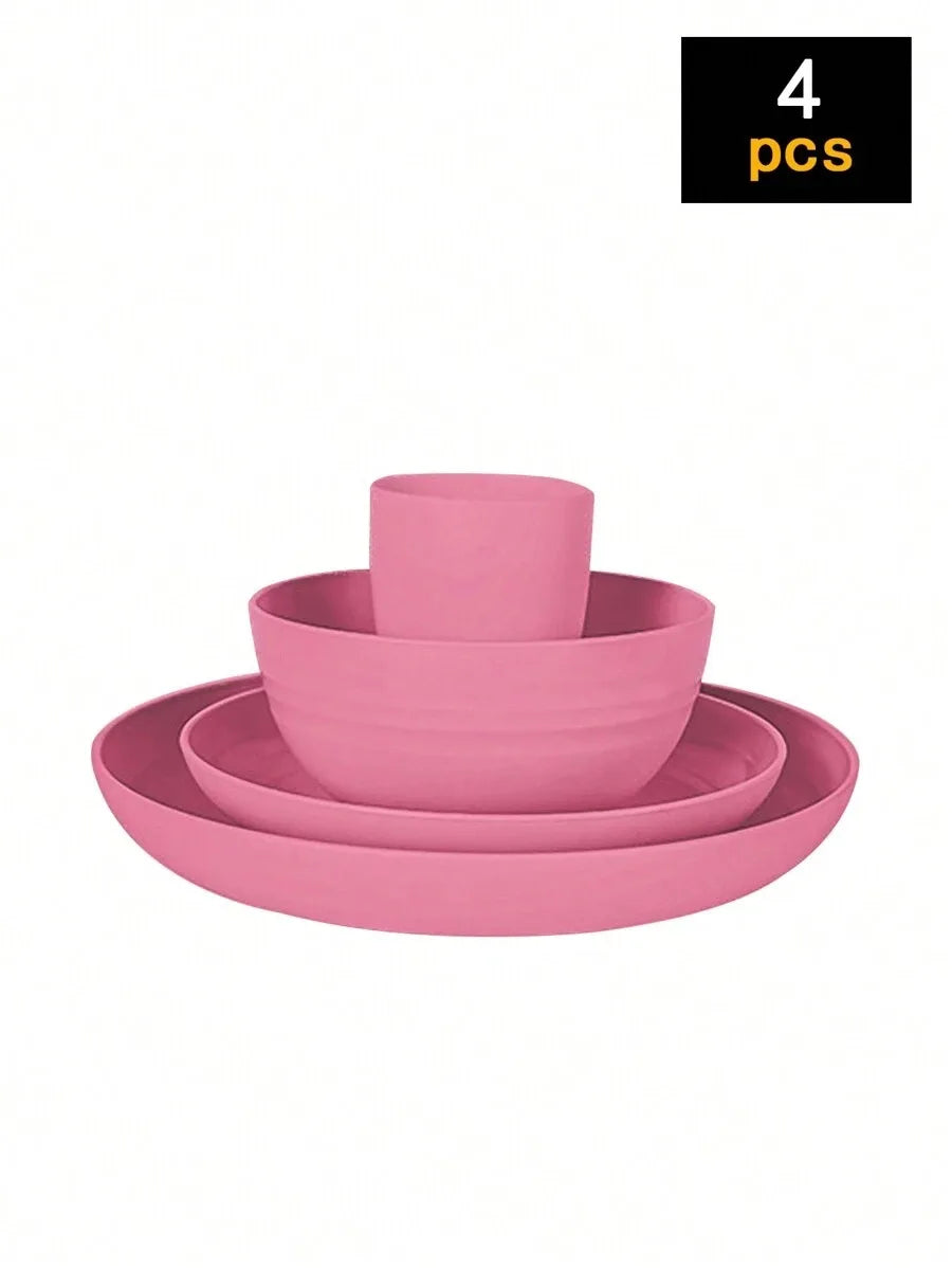 A stack of four pink reusable plastic tableware items including a bowl and plates.