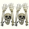 A set of Halloween skeleton bone garden stakes featuring skull and hand designs.