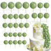 A set of light green foam cake toppers on sticks, including various sizes and shapes.