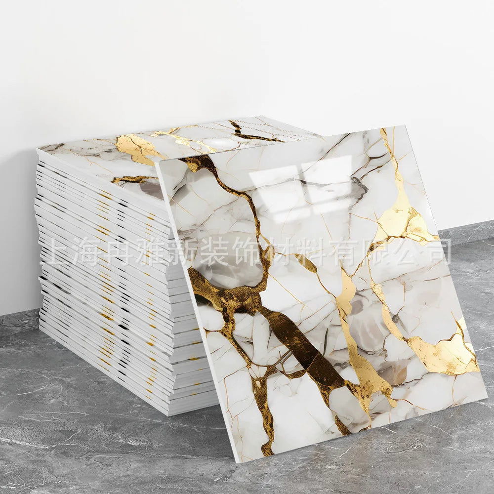 Stack of faux marble 3D self-adhesive wall tiles featuring white marble with gold veining