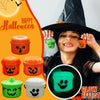 A child wearing a witch hat holds miniature pumpkin Halloween buckets for treats and decor, showing a glow effect.
