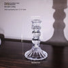 Elegant clear glass pillar candle holder with a tiered design and a flared base.
