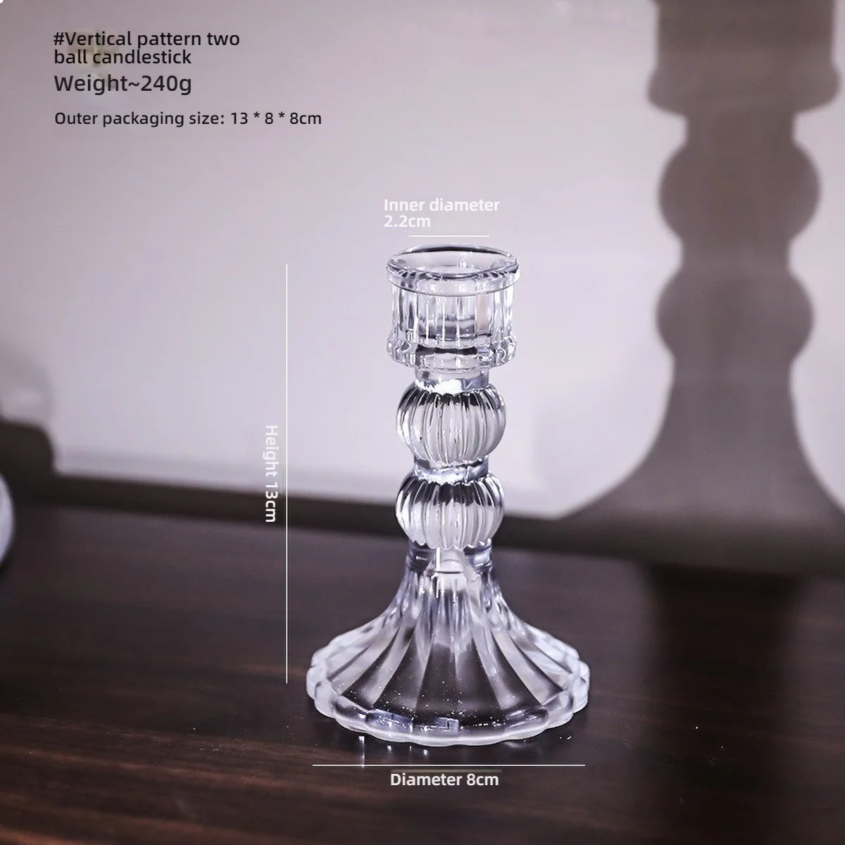 Elegant clear glass pillar candle holder with a tiered design and a flared base.