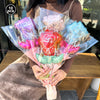 A bouquet of red and pink heart-shaped balloons with foil finish held by a person.